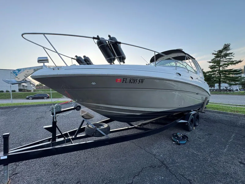 Slide: The Image of 2006 Sea Ray 280 Sundancer boat on trailer, parked outdoors. - 8