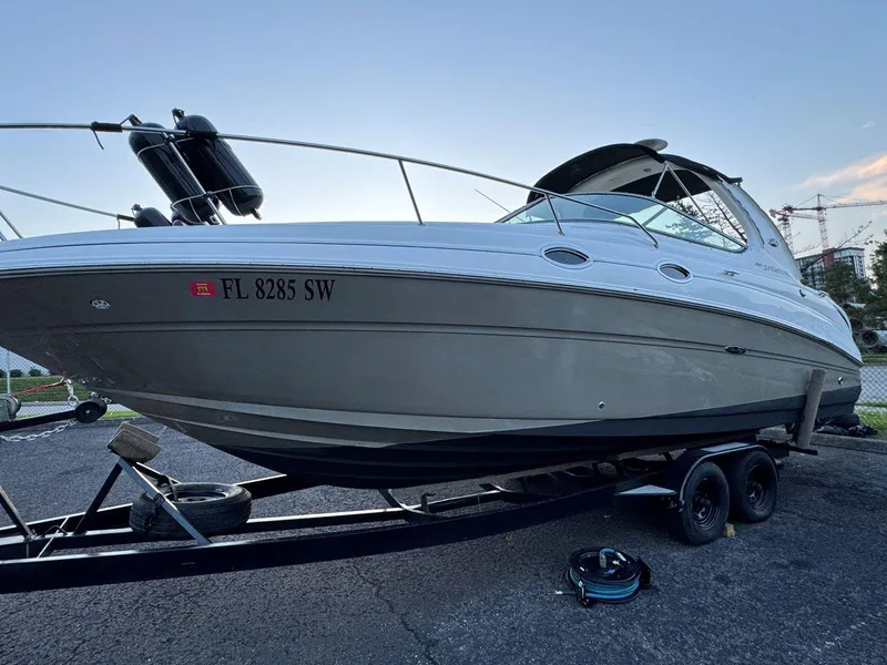 Slide: The Image of 2006 Sea Ray 280 Sundancer boat on trailer, parked outdoors. - 9