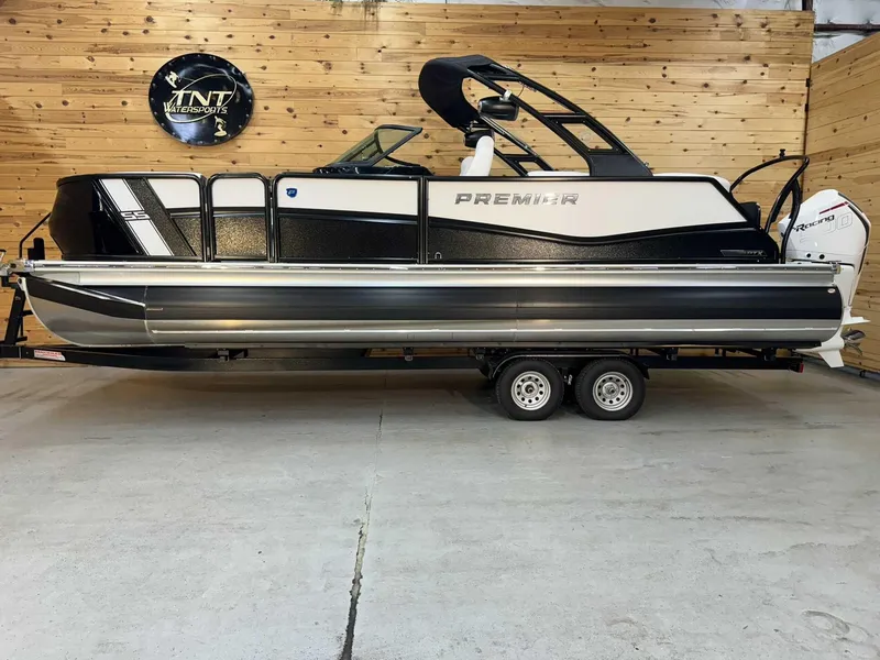 The Image of 2024 Premier 250 Super Sport pontoon boat on trailer in showroom. - 1