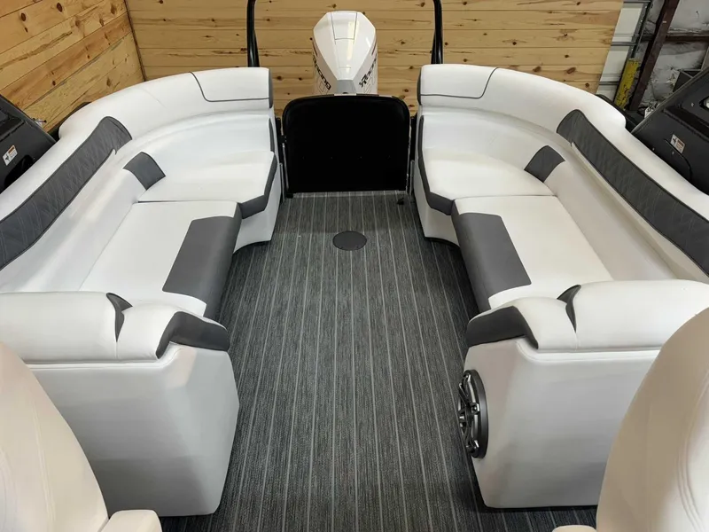Slide: The Image of 2024 Premier 250 Super Sport boat interior with white and gray seating, wood paneling, and carpeted floor. - 10