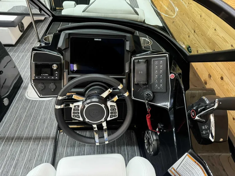 Slide: The Image of 2024 Premier 250 Super Sport boat dashboard with modern controls and sleek steering wheel. - 11