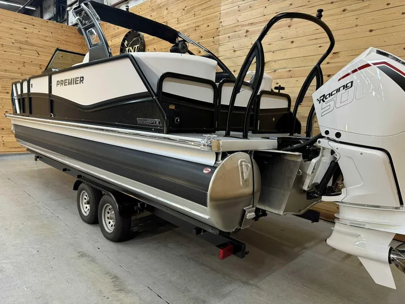 Slide: The Image of 2024 Premier 250 Super Sport pontoon boat on trailer, featuring a powerful outboard motor. - 2