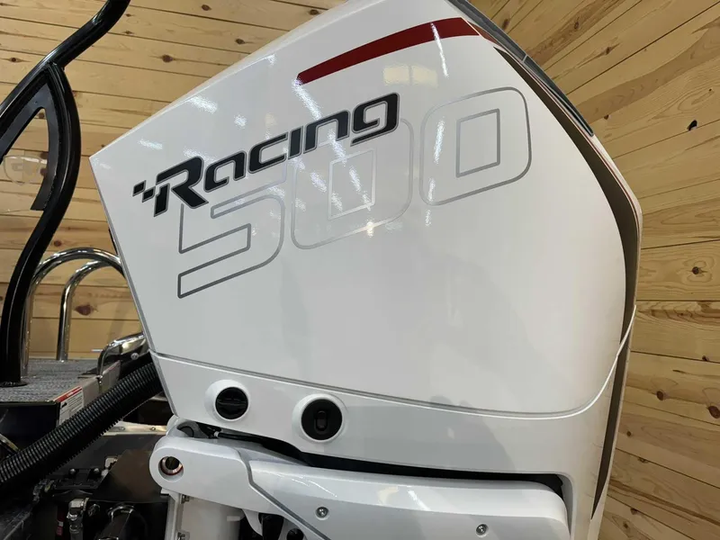 Slide: The Image of 2024 Premier 250 Super Sport outboard motor with "Racing 500" branding, wooden background. - 3