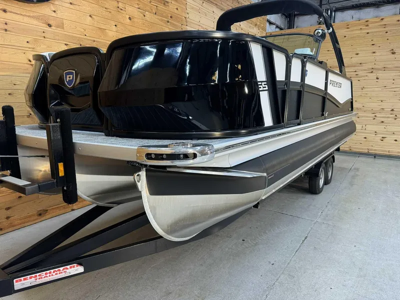 Slide: The Image of 2024 Premier 250 Super Sport pontoon boat in showroom, black and silver design. - 4