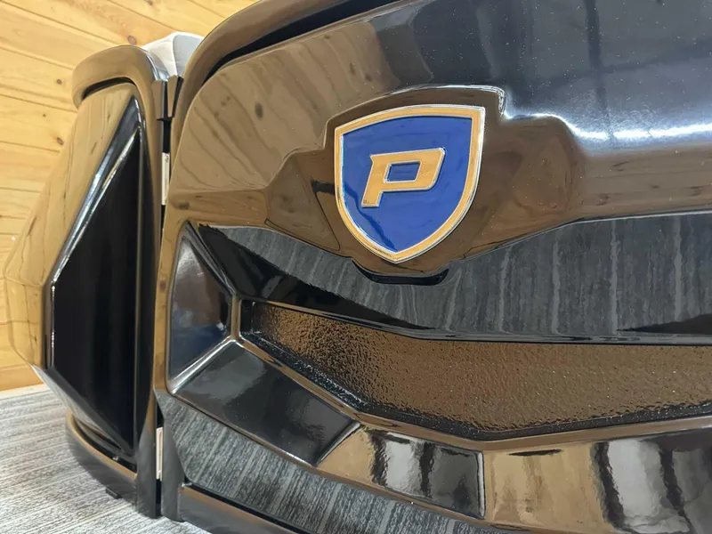 Slide: The Image of 2024 Premier 250 Super Sport, close-up of front grille with logo in a wooden setting. - 5