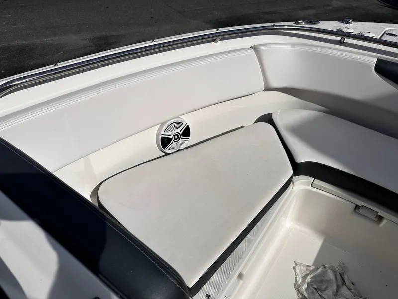 Slide: The Image of 2019 Robalo R247 Dual Console boat interior with cushioned seating and speaker. - 10
