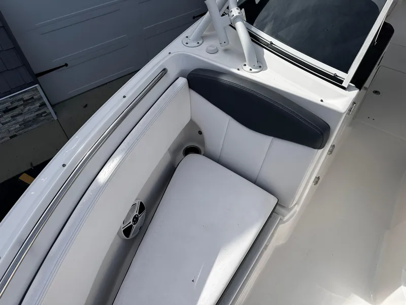 Slide: The Image of 2019 Robalo R247 Dual Console boat interior with cushioned seating and speaker. - 13