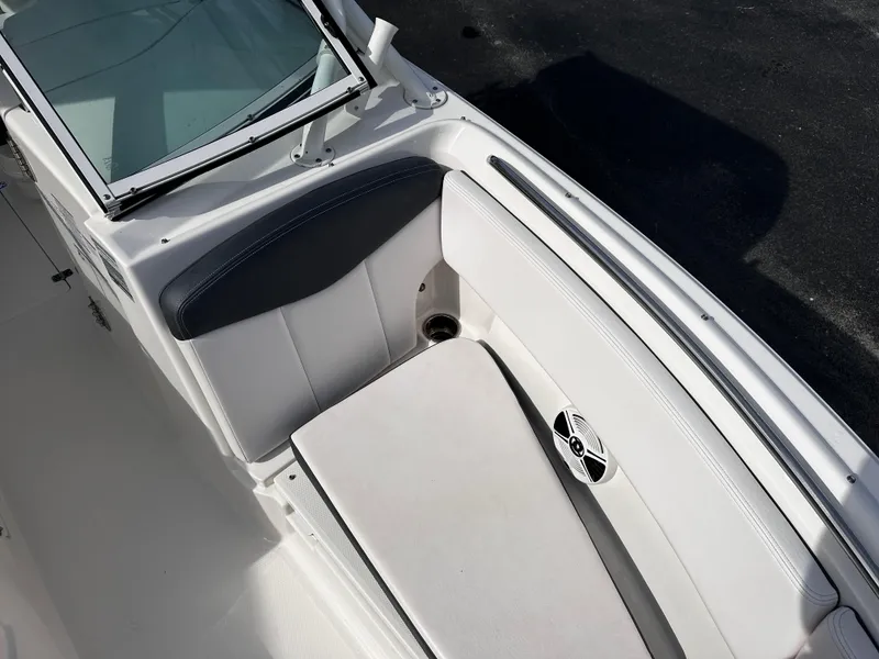 Slide: The Image of 2019 Robalo R247 Dual Console boat interior with cushioned seating and speaker. - 14