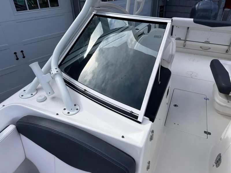 Slide: The Image of 2019 Robalo R247 Dual Console boat interior with seating and windshield. - 16