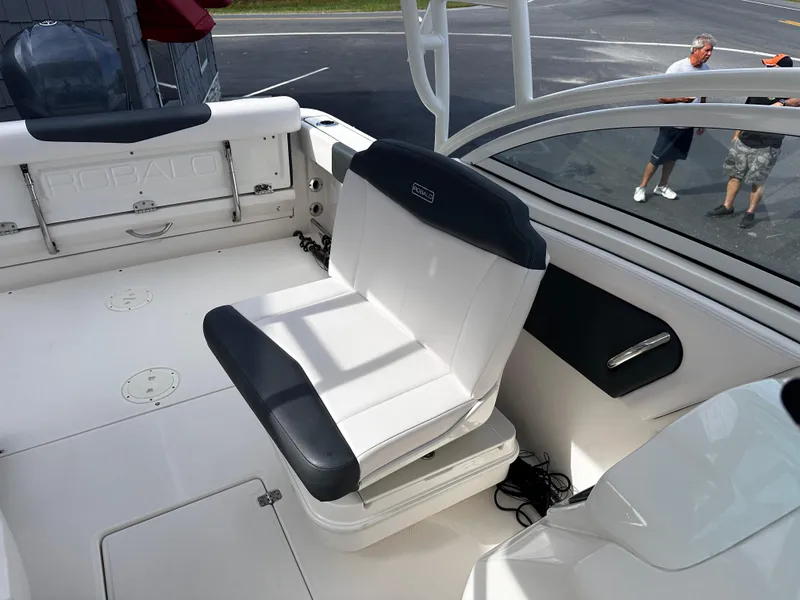 Slide: The Image of 2019 Robalo R247 Dual Console boat interior with white seating and deck. - 17