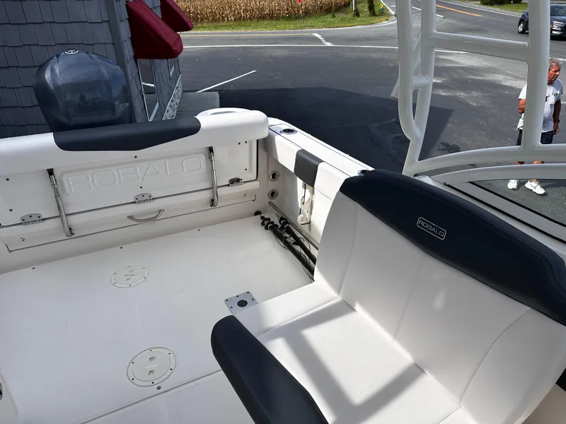 Slide: The Image of 2019 Robalo R247 Dual Console boat interior with seating and storage. - 19