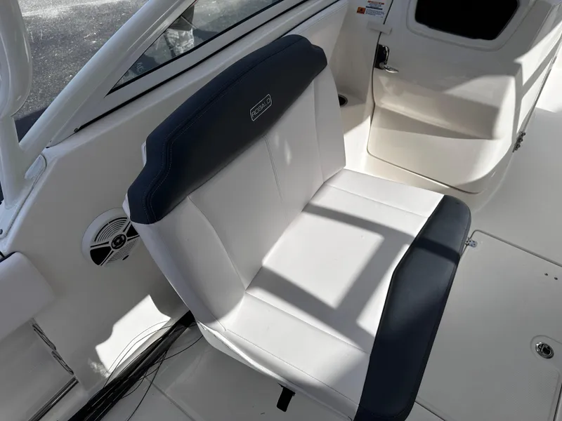 Slide: The Image of 2019 Robalo R247 Dual Console boat seat, white and navy upholstery. - 25