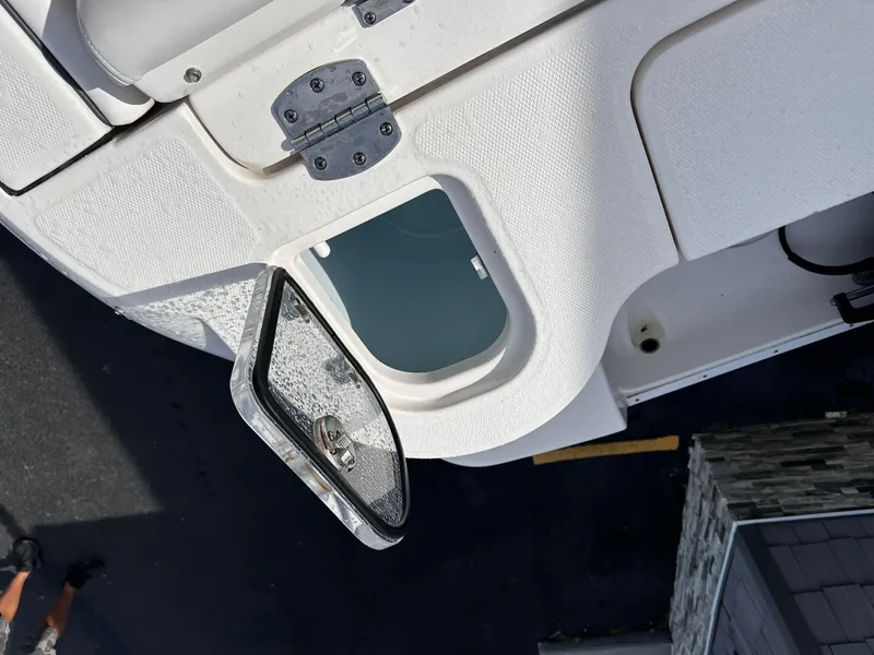 Slide: The Image of 2019 Robalo R247 Dual Console boat hatch detail, open on a sunny day. - 32