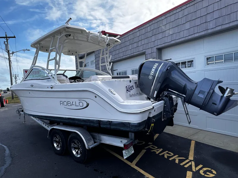 Slide: The Image of 2019 Robalo R247 Dual Console boat on trailer with Yamaha outboard motor. - 5