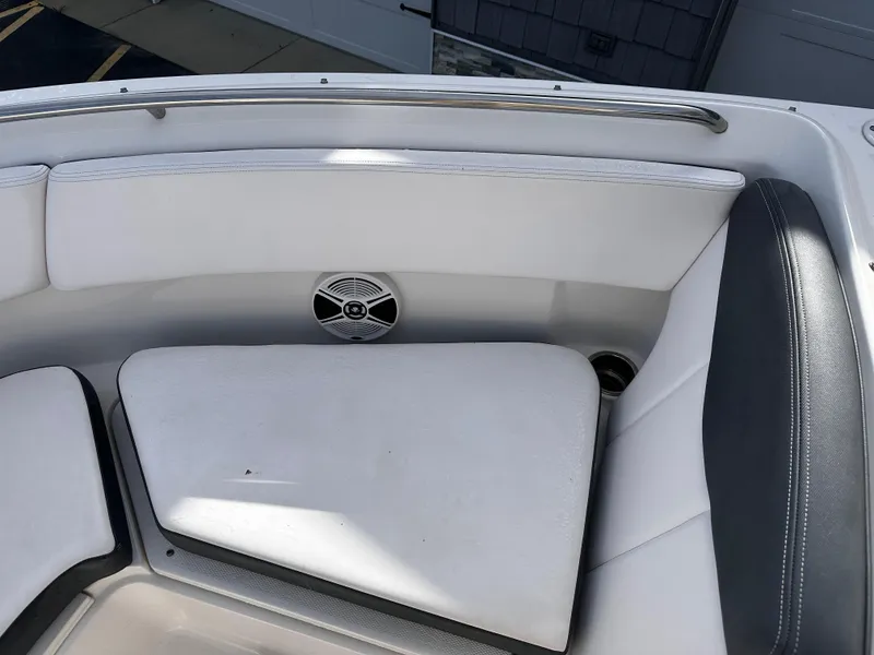 Slide: The Image of 2019 Robalo R247 Dual Console boat interior with white seating and speaker. - 9