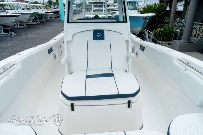 Slide: The Image of 2025 Sea Fox 288 Commander Center Console boat interior with white seating. - 11