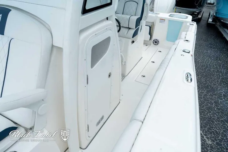 Slide: The Image of 2025 Sea Fox 288 Commander Center Console boat interior with seating and storage. - 12