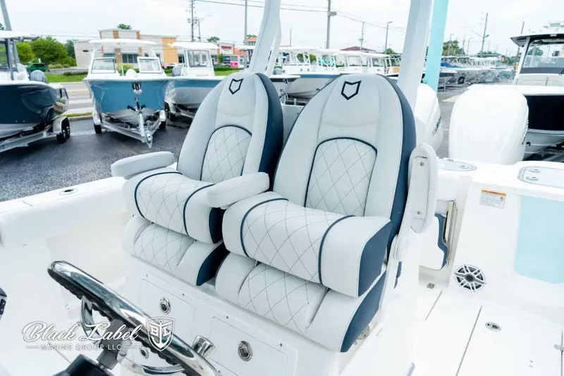 Slide: The Image of 2025 Sea Fox 288 Commander Center Console with luxurious seating in a boat showroom. - 15