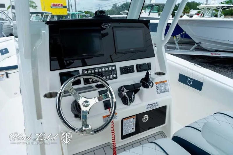 Slide: The Image of 2025 Sea Fox 288 Commander Center Console dashboard with steering wheel and controls. - 17