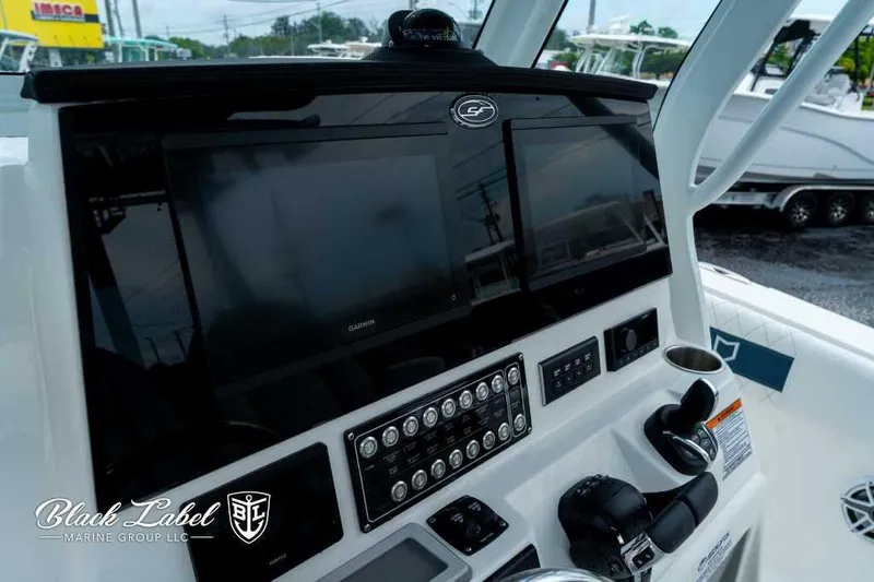 Slide: The Image of 2025 Sea Fox 288 Commander Center Console dashboard with dual screens and controls. - 18