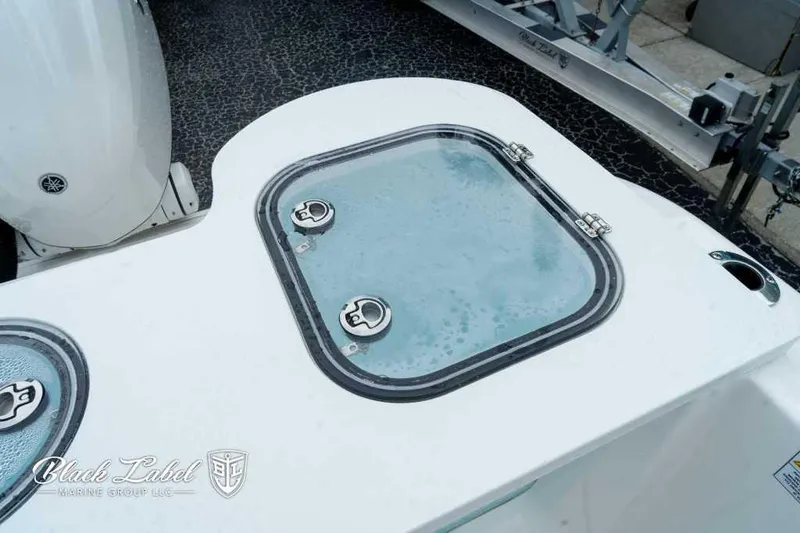 Slide: The Image of 2025 Sea Fox 288 Commander Center Console boat deck with storage hatch. - 24