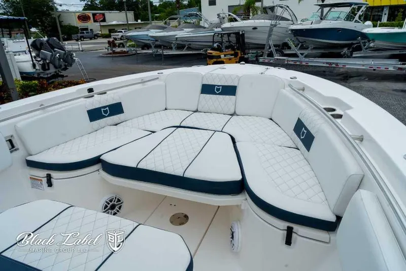 Slide: The Image of 2025 Sea Fox 288 Commander Center Console with luxurious seating in a showroom. - 7