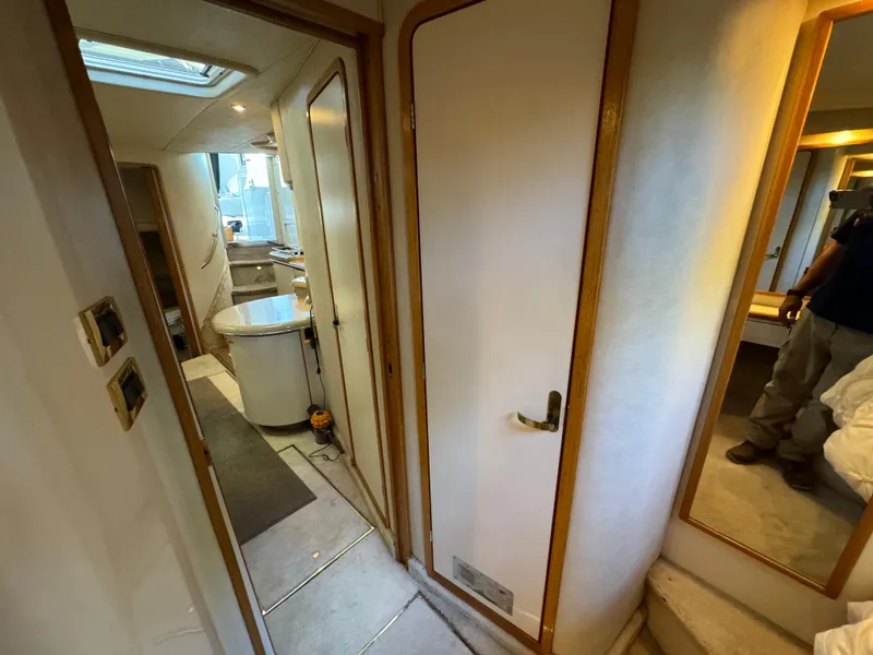 Slide: The Image of Interior of 1997 Sea Ray 450 Sundancer yacht, featuring hallway and cabin area. - 12