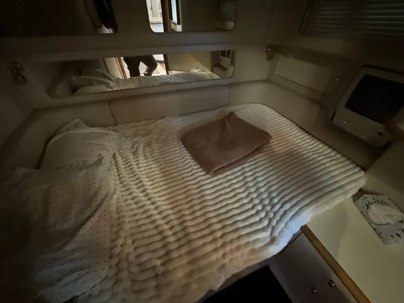 Slide: The Image of Cozy cabin interior of 1997 Sea Ray 450 Sundancer with bed and mirror. - 21