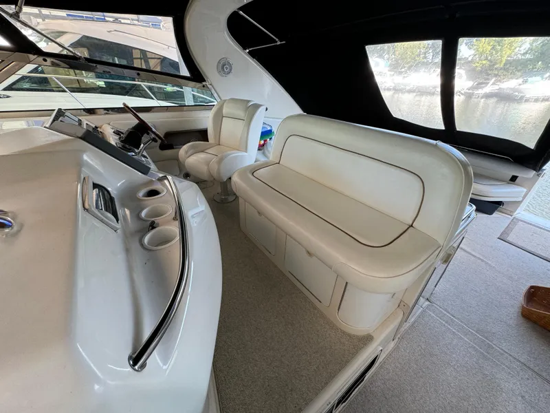 Slide: The Image of 1997 Sea Ray 450 Sundancer interior with white seating and helm station. - 26