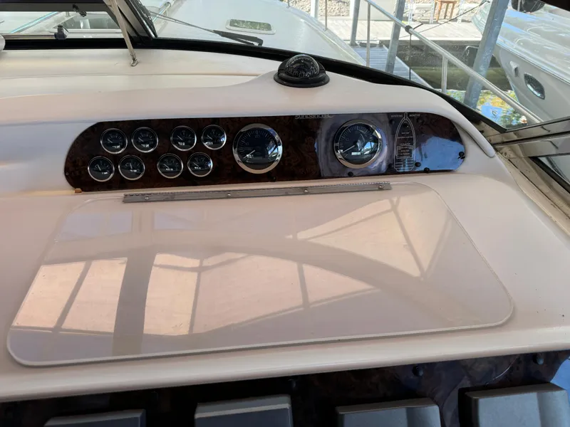 Slide: The Image of Control panel of a 1997 Sea Ray 450 Sundancer boat, featuring gauges and navigation instruments. - 27