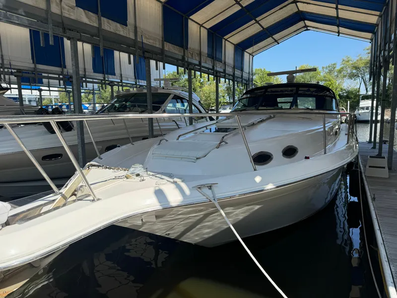 Slide: The Image of 1997 Sea Ray 450 Sundancer yacht docked under a covered marina. - 3