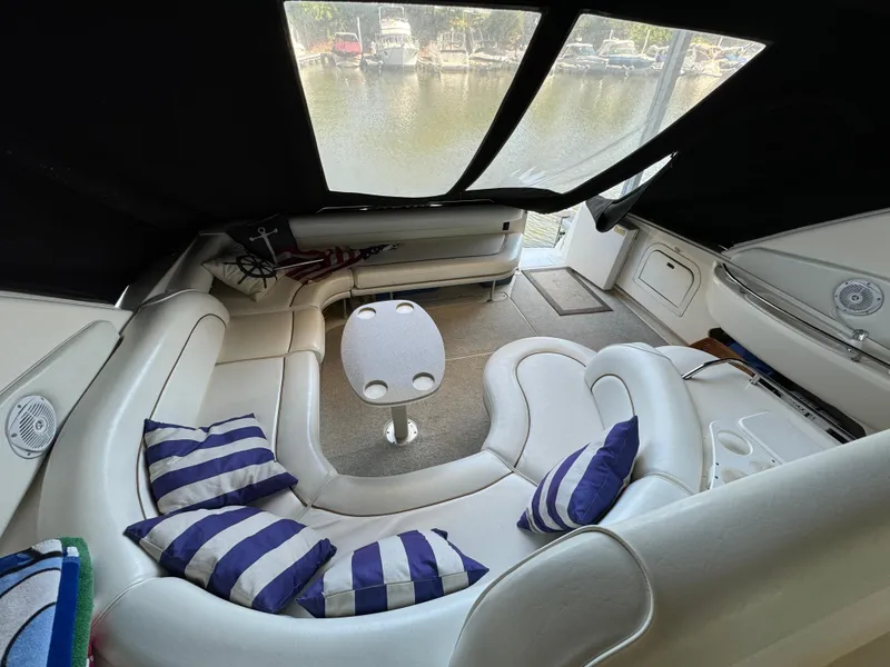 Slide: The Image of Luxurious 1997 Sea Ray 450 Sundancer interior with striped cushions and a small table. - 30