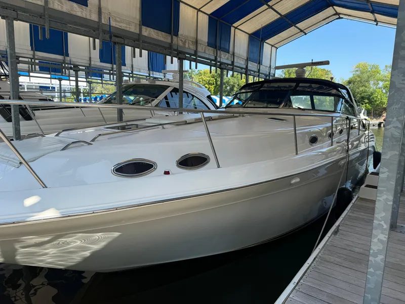 Slide: The Image of 1997 Sea Ray 450 Sundancer docked under a blue canopy. - 4