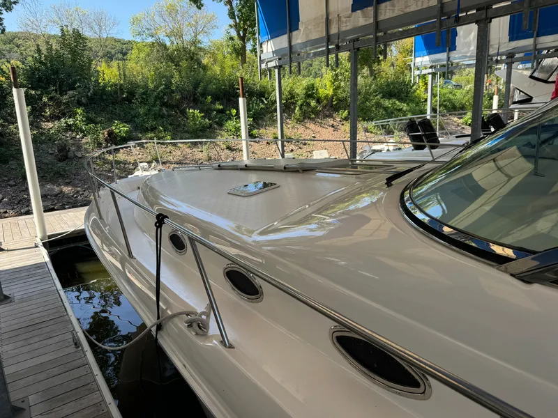 Slide: The Image of 1997 Sea Ray 450 Sundancer docked, showcasing sleek design and spacious deck. - 5