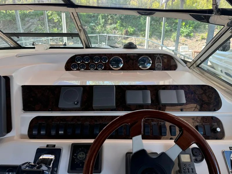 Slide: The Image of Cockpit view of 1997 Sea Ray 450 Sundancer with steering wheel and control panel. - 7