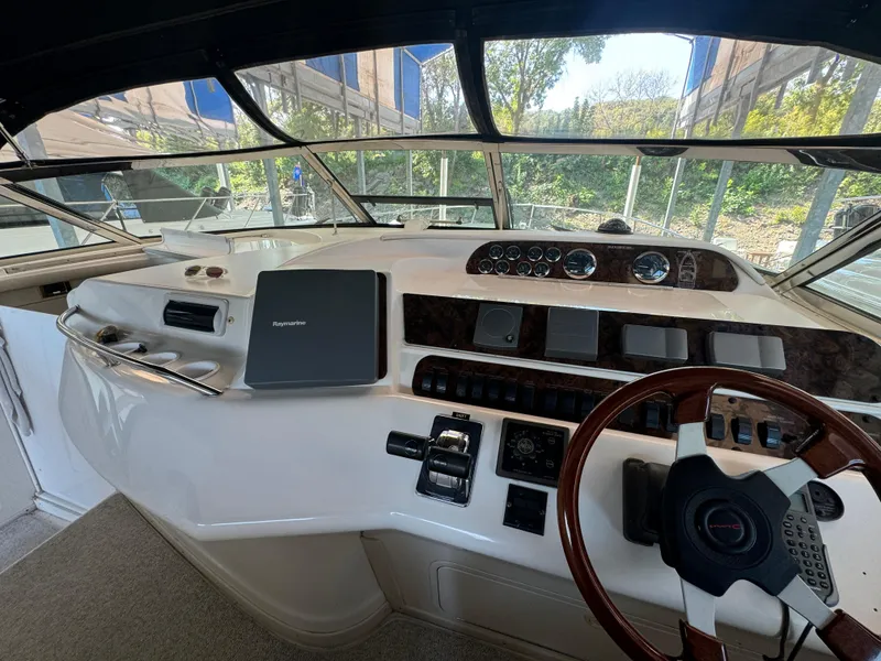 Slide: The Image of Cockpit of 1997 Sea Ray 450 Sundancer with steering wheel and navigation equipment. - 8