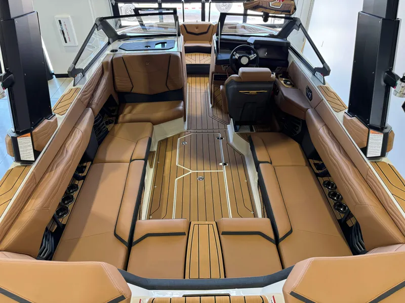 Slide: The Image of 2025 Nautique Super Air Nautique G23 interior with luxurious leather seating. - 11