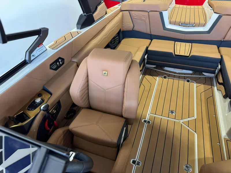 Slide: The Image of 2025 Nautique Super Air Nautique G23 interior with tan leather seating. - 19
