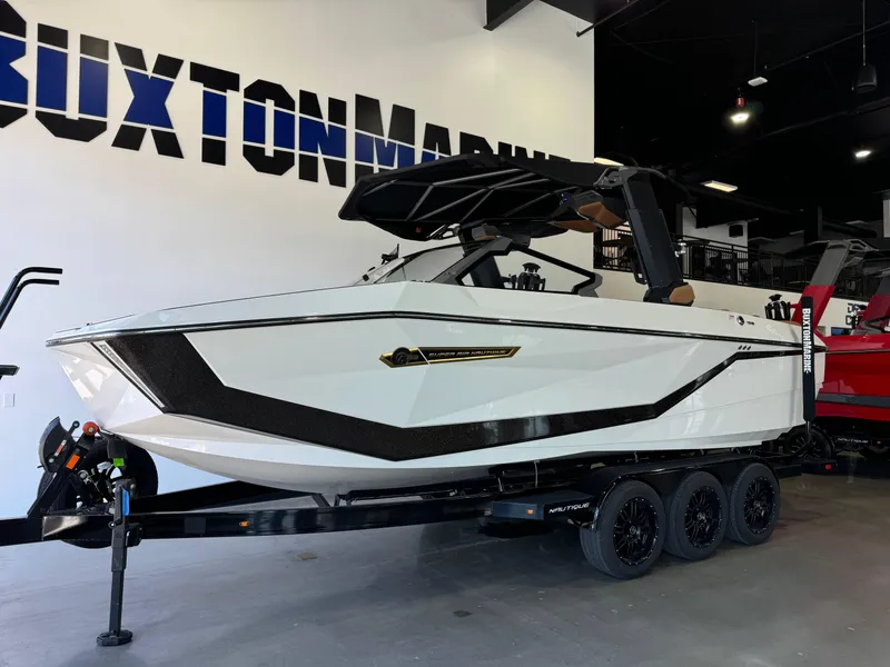 Slide: The Image of 2025 Nautique Super Air Nautique G23 boat in showroom. - 3