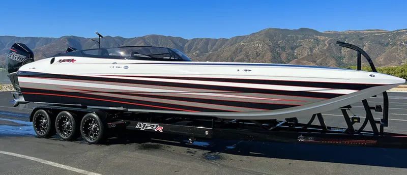 The Image of 2023 Daves Custom Boats M28R on trailer, scenic mountain backdrop. - 0