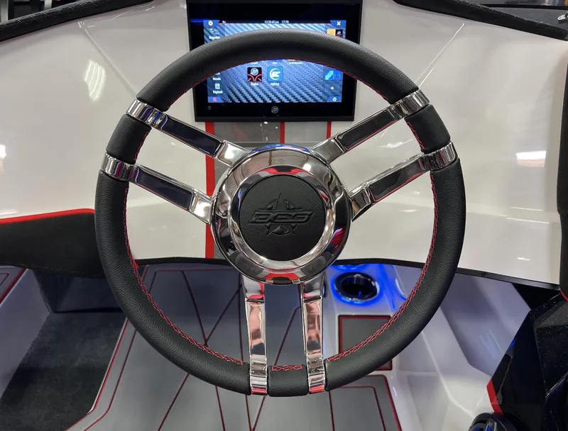 Slide: The Image of 2023 Daves Custom Boats M28R steering wheel and dashboard with touchscreen display. - 13