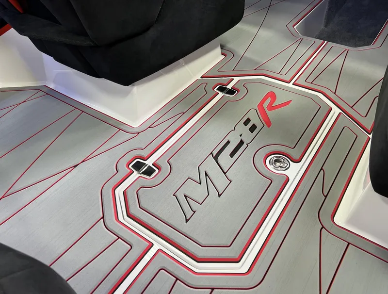 Slide: The Image of 2023 Daves Custom Boats M28R interior floor design with red accents. - 4