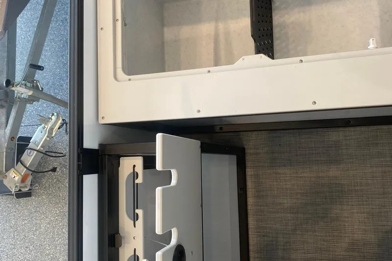 Slide: The Image of Interior view of 2025 Lowe SF 212 W boat storage compartment with open hatch. - 12