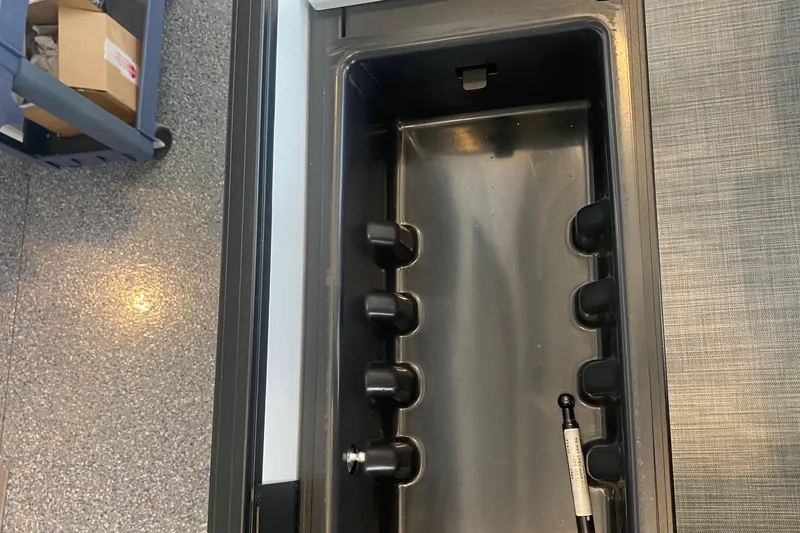 Slide: The Image of Interior compartment of a 2025 Lowe SF 212 W boat, featuring storage space. - 14