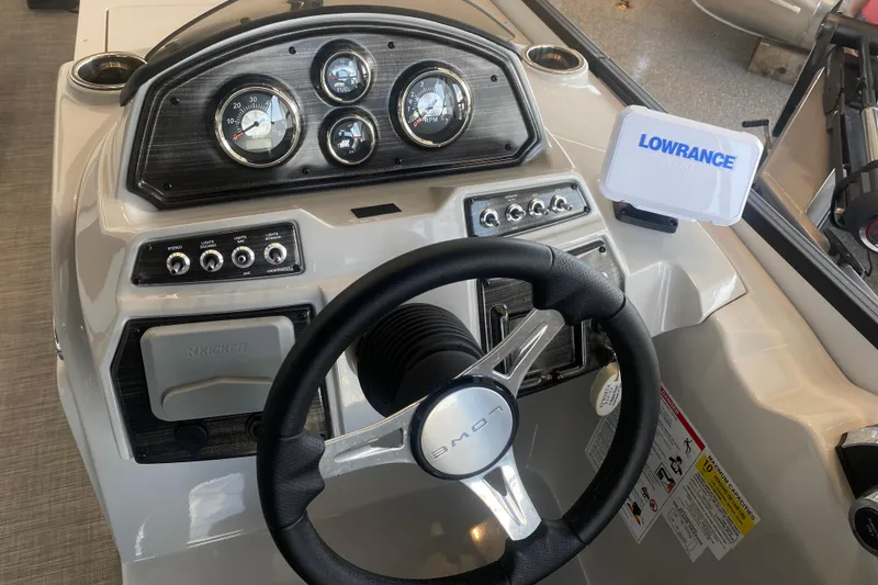 Slide: The Image of 2025 Lowe SF 212 W boat dashboard with steering wheel and Lowrance display. - 17