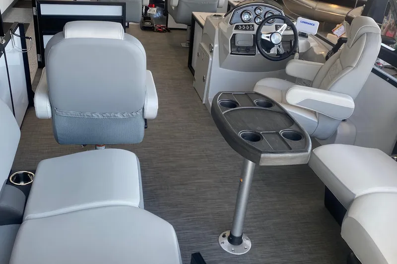 Slide: The Image of Interior of 2025 Lowe SF 212 W pontoon boat with modern seating and steering console. - 7
