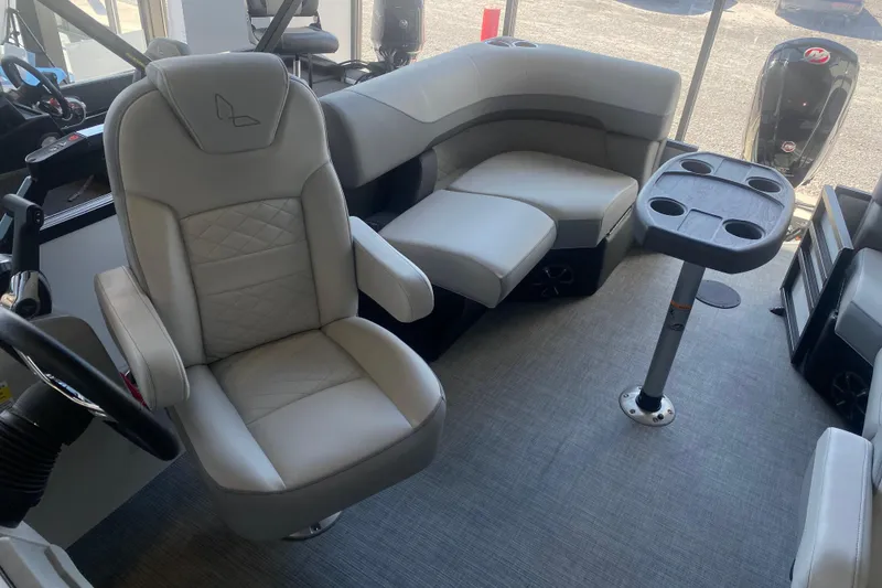 Slide: The Image of Interior of 2025 Lowe SF 212 W boat with plush seating and table. - 8