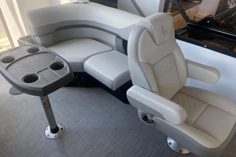 Slide: The Image of Luxurious seating on 2025 Lowe SF 212 W boat with cupholder table. - 9