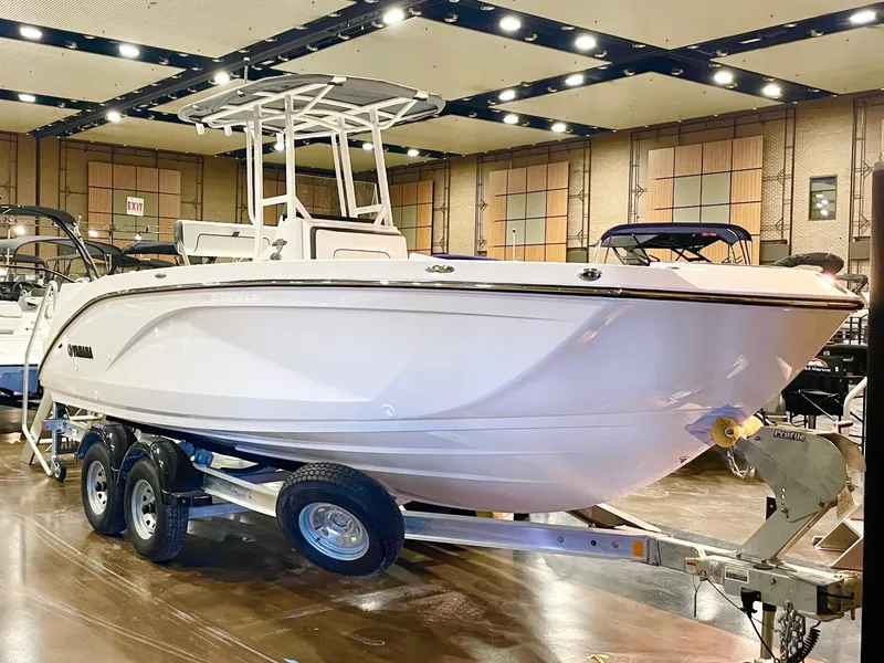 The Image of 2025 Yamaha Boats 220 FSH Sport displayed indoors on a trailer. - 0