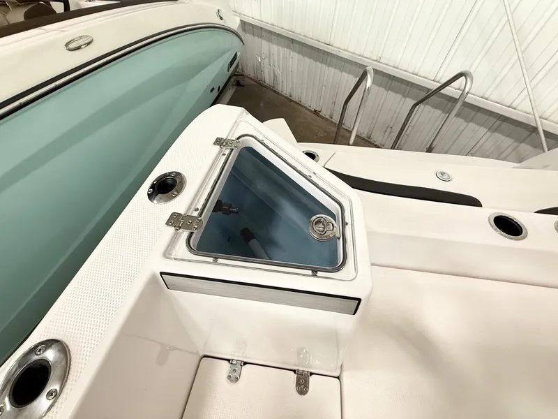Slide: The Image of 2025 Yamaha Boats 220 FSH Sport deck with storage compartment and sleek design. - 10